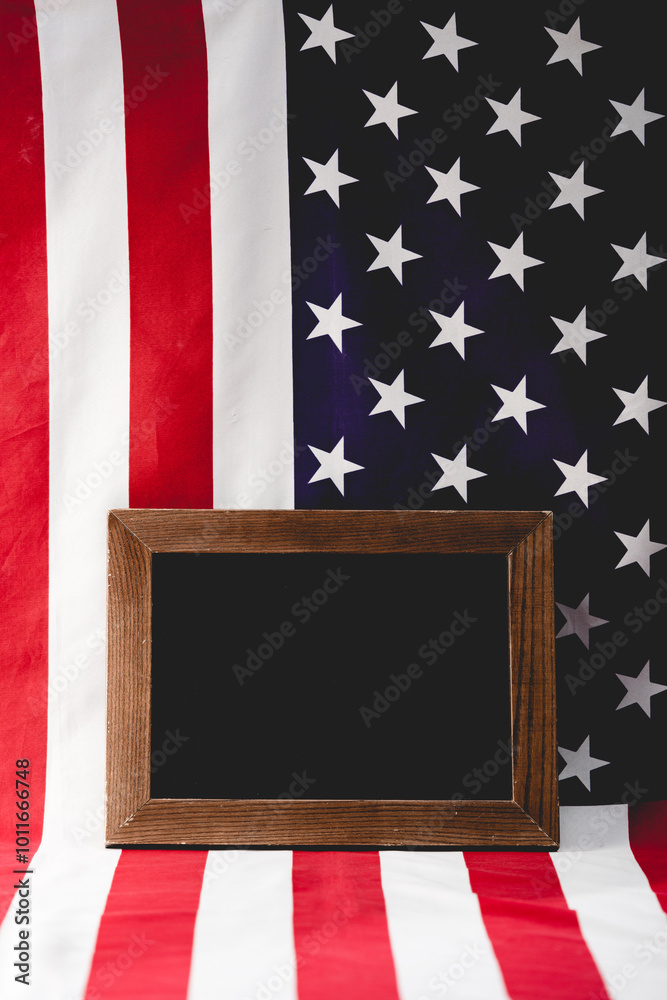 Wall mural A wooden frame stands empty before the American flag, symbolizing remembrance and honor for national heroes.