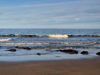 Sunlit Summer Day At The Ocean Shoreline
