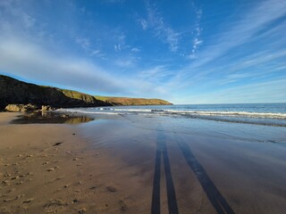 Summer Serenity: Waves Lapping At The Sunlit Shoreline
