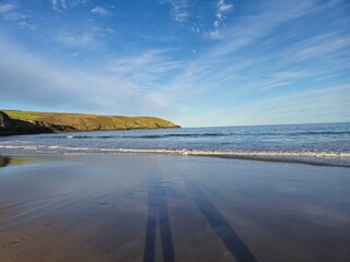 Relaxing Summer Day At The Beach: Waves And Blue Ocean Along The Shoreline