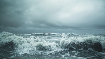 Dark, tumultuous ocean waves crash under a stormy sky, capturing the raw power and intensity of nature in a dramatic, breathtaking scene.