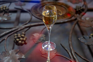 Tasting of brut and reserve grand cru champagne sparkling wine produced by traditional method in underground caves in Champagne, France, close up