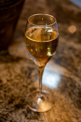 Tasting of brut and reserve grand cru champagne sparkling wine produced by traditional method in underground caves in Champagne, France, close up