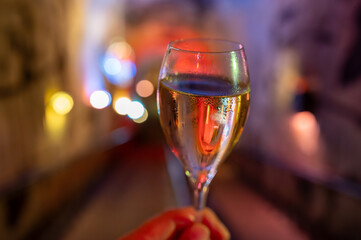 Tasting of brut and reserve grand cru champagne sparkling wine produced by traditional method in underground caves in Champagne, France, close up