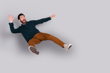 Photo of anxious embarrassed man wear stylish green clothes look empty space isolated on gray color background