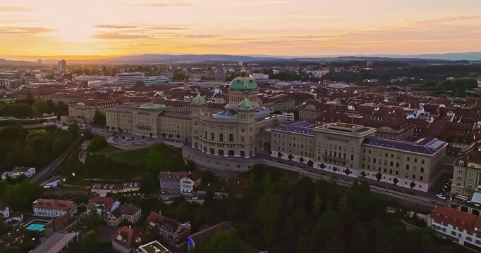 Aerial view over the city of Bern the capital city of Switzerland the historic district from above. Bern old town. The historic buildings in the city center. Wide establishing aerial golden sunset