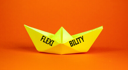 Flexibility symbol. Concept word Flexibility on beautiful yellow paper boat. Beautiful orange...