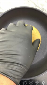 Making an arepas or tortillas on a hot non stick pan.