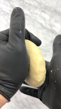 The art of kneading corn dough to make delicious Colombian arepas or Mexican sopes