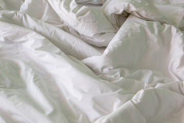 wrinkle messy blanket after waking up in the morning from sleeping in a long night, details of duvet and blanket.