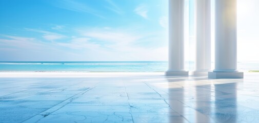 Obraz premium Serene beachfront view with classic pillars, bright skies, and calm ocean waters.