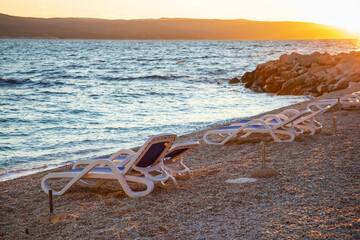 Sun setting at the pebble beach in Brela, Croatia