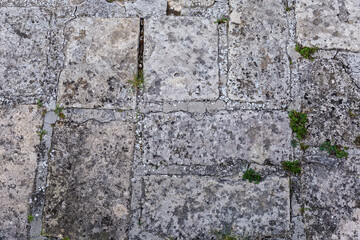 Fragment of stone wall of ancient castle close-up