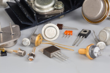 Old transistors various purpose in different packages on gray surface