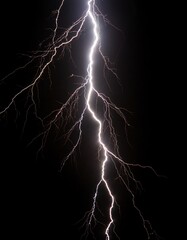 Lightning strike illuminating a stormy night sky