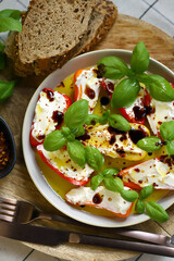 Mini peppers stuffed with cream cheese in olive oil with basil