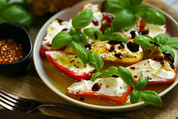 Mini peppers stuffed with cream cheese in olive oil with basil