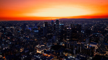Obraz premium Vast panorama of a stunning Los Angeles, California, USA at twilight time. City scenery at the backdrop of orange sky. Aerial perspective.