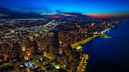 Beautiful scenery of Chicago, IL, United States at night. Multiple cars move by the luminous...