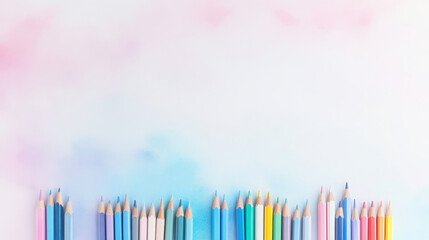 Obraz premium A vibrant array of colored pencils arranged neatly, set against a soft pastel background, perfect for artistic projects and designs.