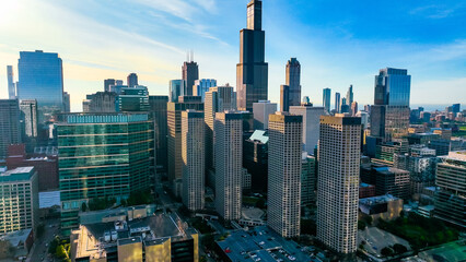 Fototapeta premium Flying above the urban landscape of modern American city. High and low buildings of Chicago, Illinois, USA.
