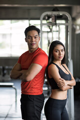 Fototapeta premium fit sporty Asian young male and female couple at fitness gym.