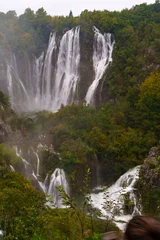 Fototapete Wasserfälle Majestic waterfalls at Plitvice Lakes National Park surrounded by greenery  © Alejandro