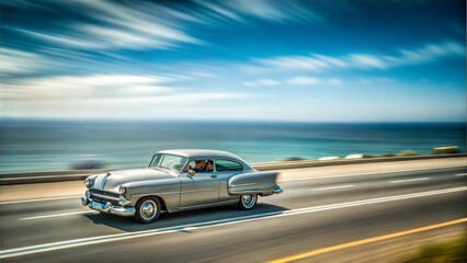 Vintage car going in a high way next to the ocean