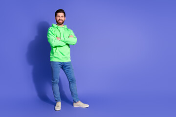 Fototapeta premium Full length photo of handsome young guy crossed hands confident dressed stylish green garment isolated on violet color background