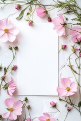 Delicate pink flowers framing a blank card on a white textured background.
