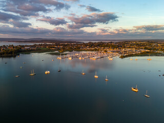 Poole sunrise Boats anchored in harbor under golden sunrise in the uk