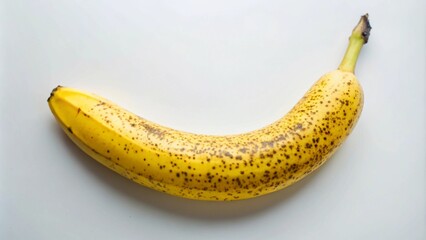 A single ripe yellow banana with brown spots on a white background.