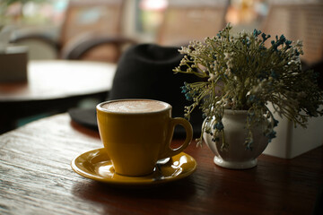 coffee cup with elegant yellow color on wooden table