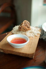 Crispy tofu with additional toppings on a wooden chopping board