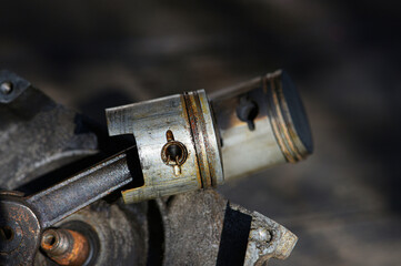 Old rusty piston of  2 stroke engine with connecting rod . Used   piston of a  lawn mower .