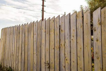 Wooden fence without foundation. Fence made of planks