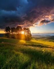 Dramatic Sunset Over Green Field and Valley in Evening Wild Landscape