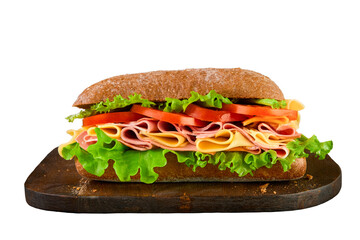 Sandwich big submarine sandwich with ham, cheese, lettuce, tomatoes old wooden dark board isolated on white background with clipping path. Selective focus.