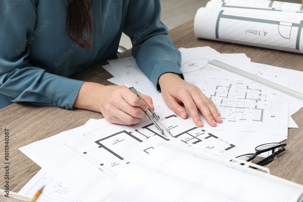 Wall mural Architect working with project, closeup. Different technical drawings on wooden table