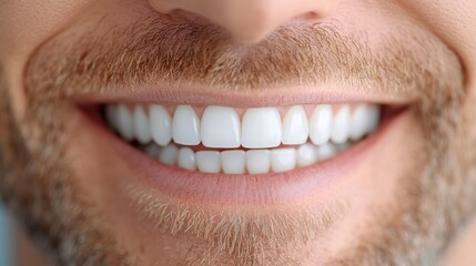 Obraz premium The image showcases a close-up view of a man's vibrant smile, highlighting his neatly groomed beard and bright, white teeth for a fresh and modern look.
