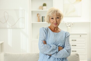 Portrait of beautiful senior woman at home, space for text