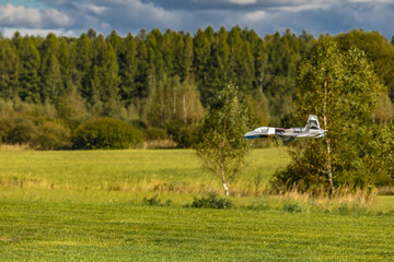 Ultralight planes flying low over a grassy airport