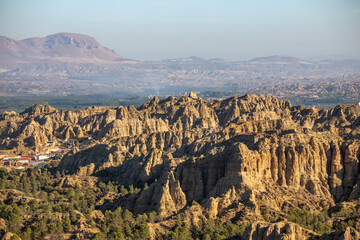Panoramic view of the badlands of Purullena, Granada, Andalusia, Spain with daylight and the town in the background. Granada Geopark