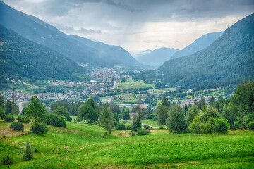 Fototapeta premium Val di Sole valley flourishing under cloudy sky, Trentino, Italy