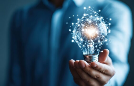 Businessman holding a glowing light bulb with interconnected digital network, symbolizing innovation and creativity in modern technology and business solutions.