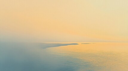 Fototapeta premium Gentle waves lap against the shore as dawn breaks with a pastel glow on the horizon