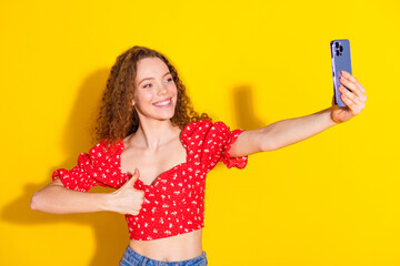 Photo portrait of lovely young lady take selfie photo thumb up dressed stylish red garment isolated on yellow color background