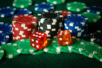 An interesting and exciting game of dice on a green poker table in a club. A winning combination of two dice of sixes brought a lot of chips