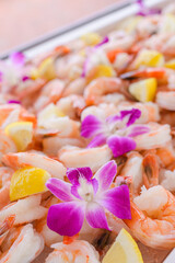  Shrimp cocktail with lemon wedges and orchids on display in Cape Cod, Massachusetts