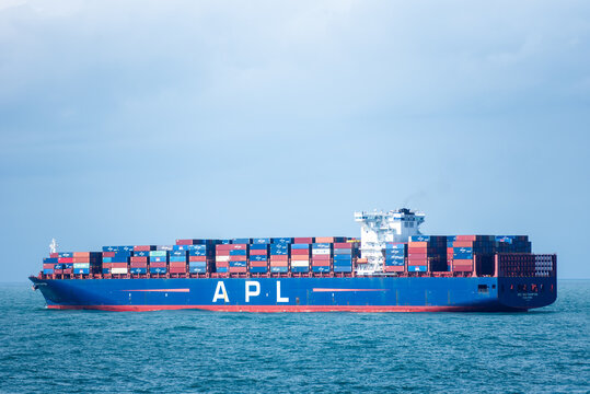 Large container ship APL Southampton sailing through Atlantic Ocean, near US coast. She is fully loaded with colorful containers.